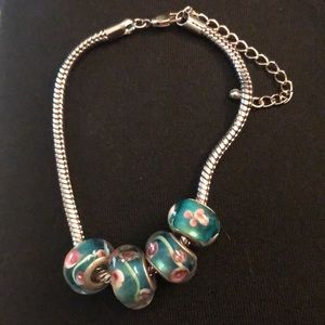 Silver tone bracelet with sliding beads from a ghost town.  Blue with pink roses